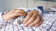 Hands in hospital bed