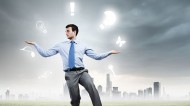 Young businessman juggling icons