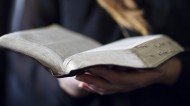 Woman holding bible (Stock photo)