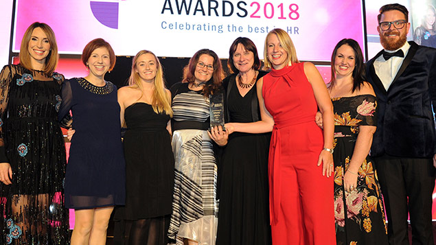 St Mungos team members pick up their Diversity and Inclusion Award (Public Sector) from the One Show's Alex Jones and Personnel Today editor Rob Moss at the 2018 awards.