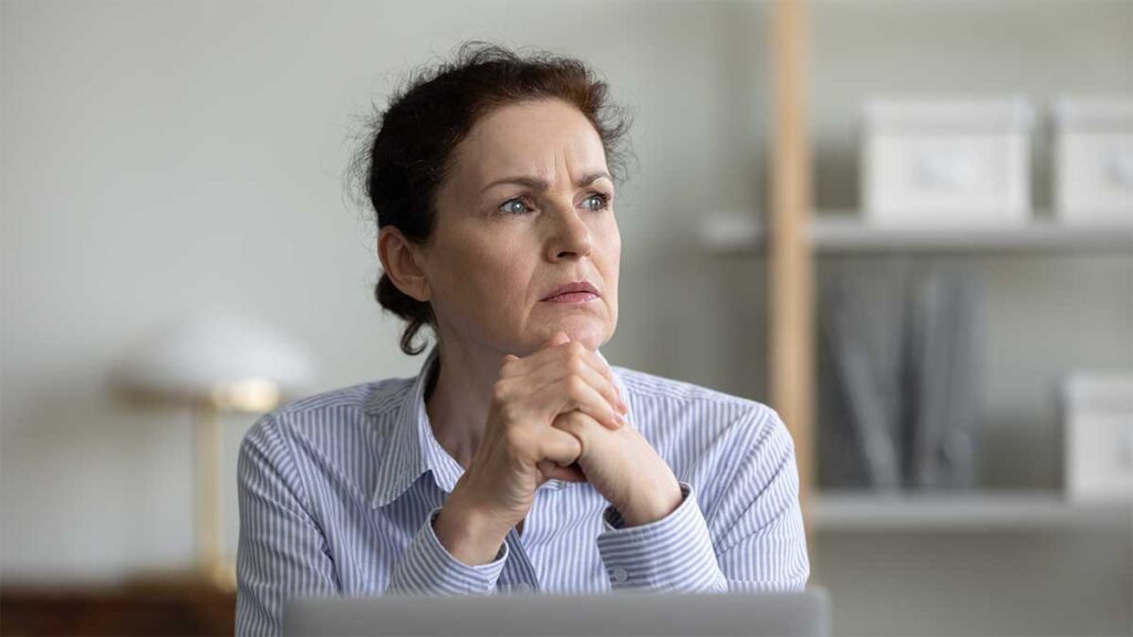 A women aged 50 looking concerned in an office