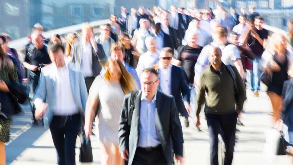 Commuters crossing a bridge