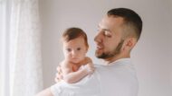A new father on paternity leave with a baby