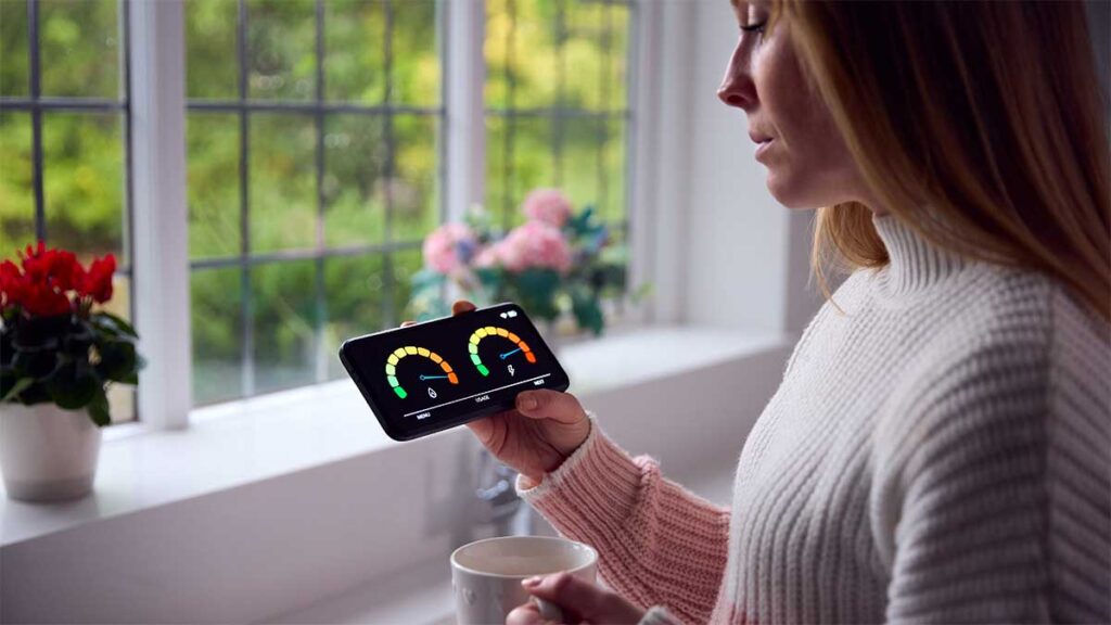A concerned woman looking at her energy usage on a smart meter