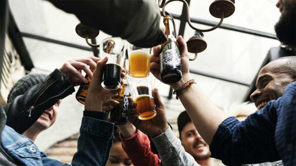 A group of people raising their glasses in a pub