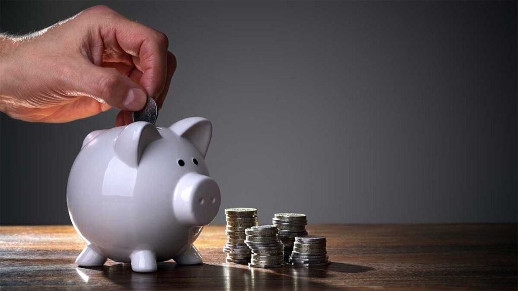 Putting coins into a piggy bank