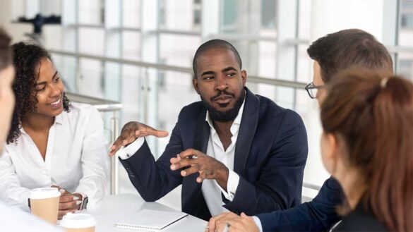 A manager briefing a team. Unlock employee productivity