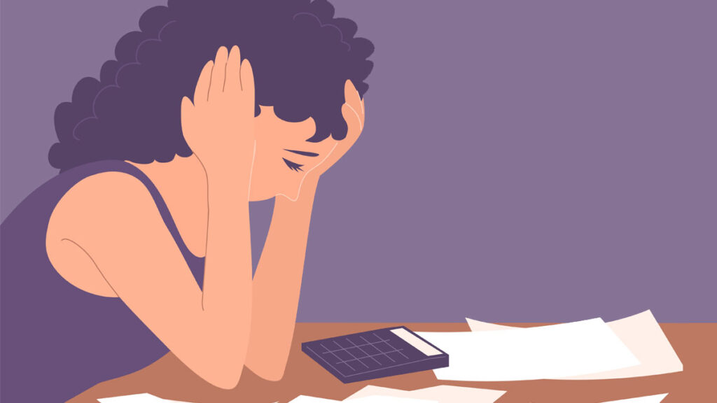 An illustration of a stressed woman looking at bills and a calculator on a table