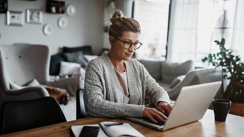 A woman working from home. To illustrate an article about disability accessible hybrid working.
