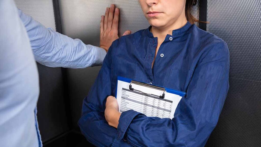 Man standing too close to woman in a lift