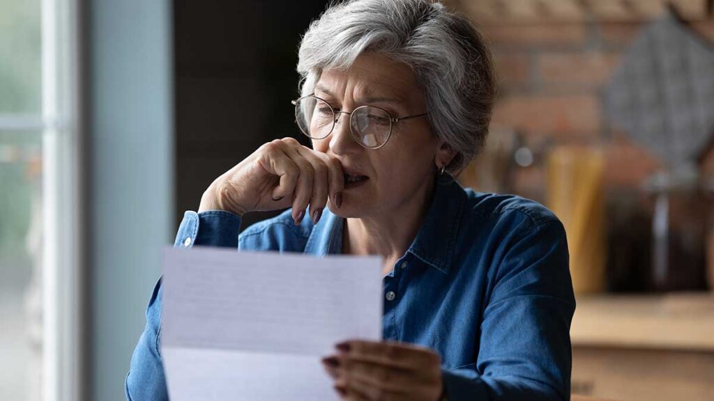 UK gender pensions gap 2023: woman looks at a pensions statement