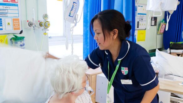 NHS Workforce plan: A nurse adjusts the pillows for a patient