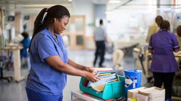 nurses discrimination: A Black nurse looking through files