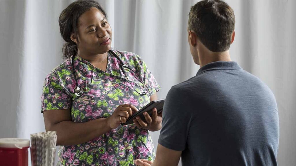 An occupational health nurse with a patient