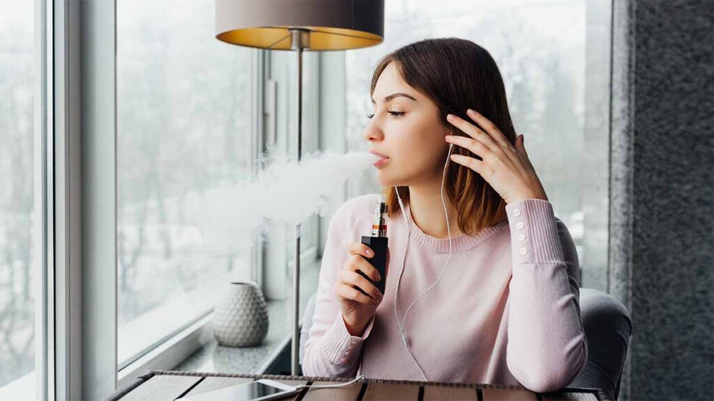 A young woman vaping