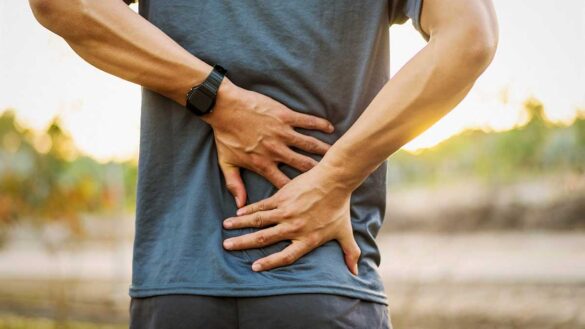 Disability discrimination Brosnan vs Coala: Photo shows man holding his back in pain.