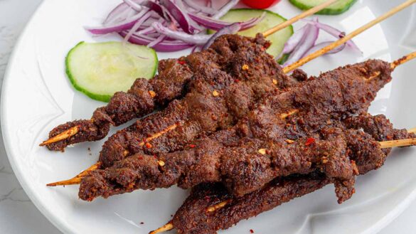 A plate of suya and salad