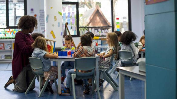 Children and an early years professional in a nursery