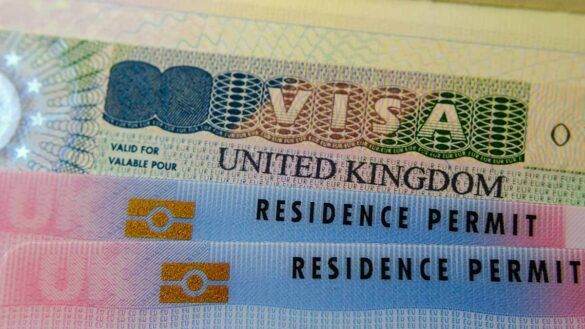 Immigration challenges: A close up of a UK visa and residence permit.