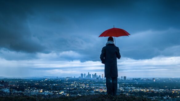 man umbrella and storm clouds