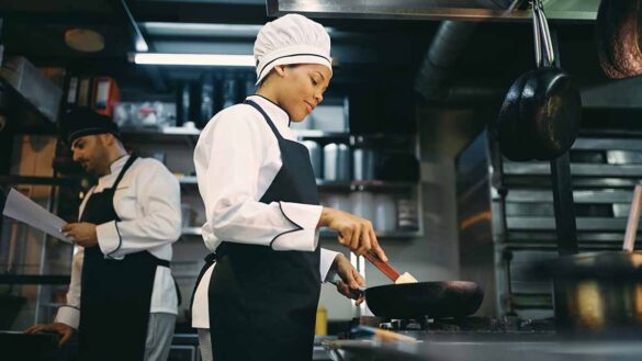 two chefs working in a kitchen