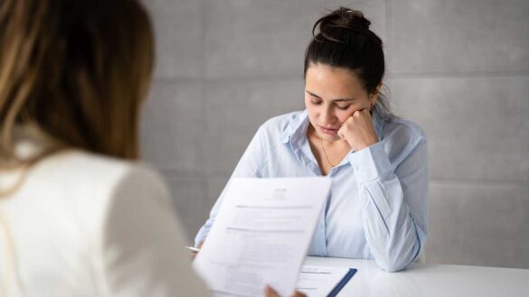 A woman attending a job interview, looking upset