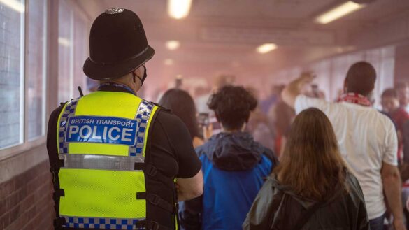 A British Transport Police officer at a busy train station