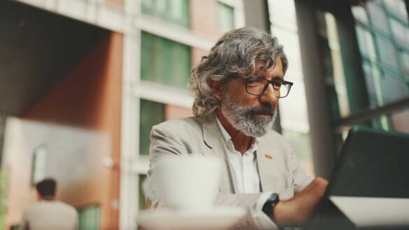 An older man working on a laptop