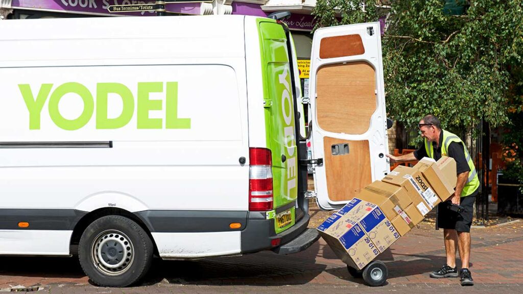 A driver unloading parcels from a Yodel delivery van