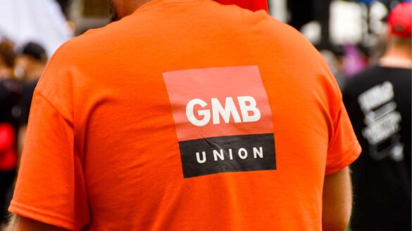 A man wearing a GMB union-branded T-shirt