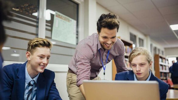 Teacher helping students in a classroom