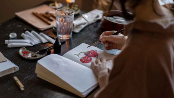 A student drawing in a sketchbook.