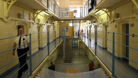 A prison officer walking on the landing in a prison in Aberdeen