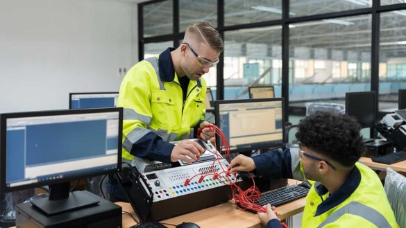 Two engineers working on equipment in an office