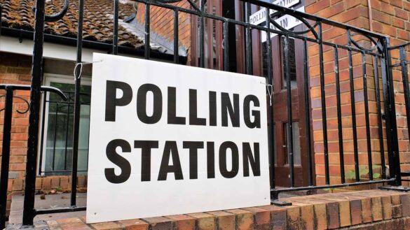 A polling station sign outside a building