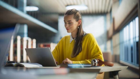 A woman using a laptop in a quiet office space