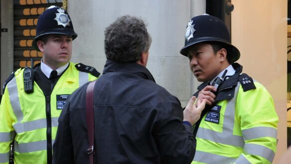 Two police officers talking to a man