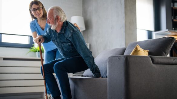 Nurse helps elderly man in home social care