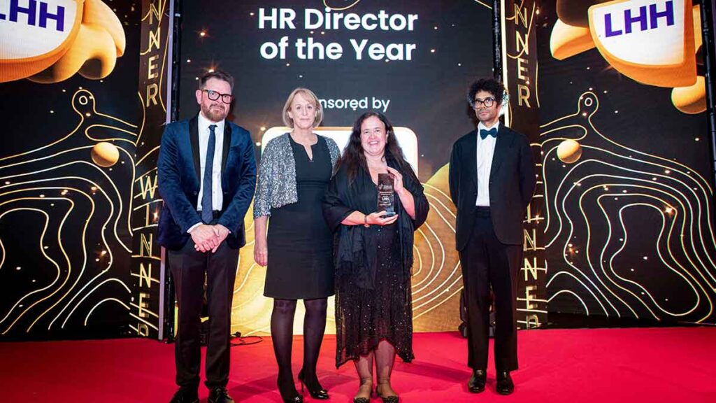 Angela Williams from Corsearch receives the HR Director of the Year trophy from LHH's JC Townend at the Personnel Today Awards 2024