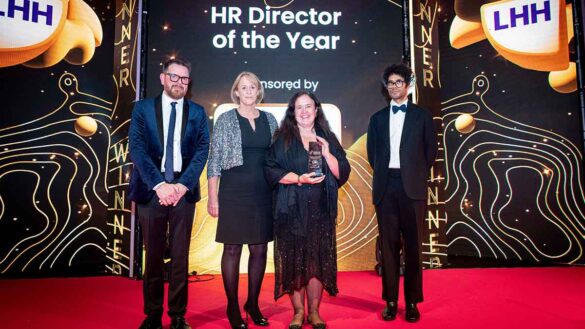 Angela Williams from Corsearch receives the HR Director of the Year trophy from LHH's JC Townend at the Personnel Today Awards 2024