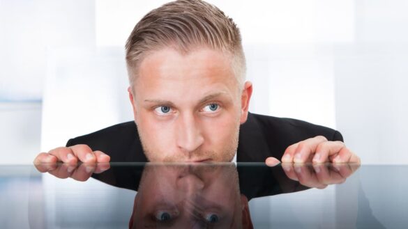 Man looking furtive in office
