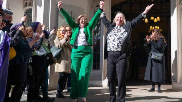 For Women Scotland leaders raise hands in the air in court victory