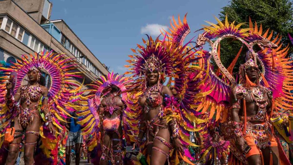 Bank holiday pay double time. Photo shows performers at Notting Hill Carnival
