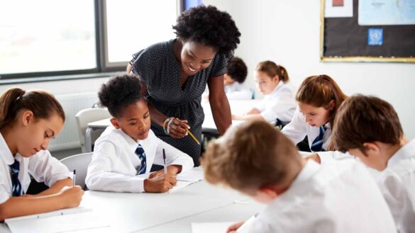 Flexible working teachers. Image shows teacher and children in a classroom