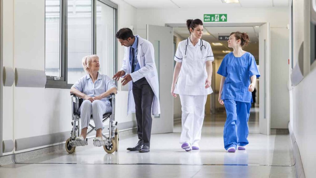 Level 7 apprenticeship funding. Photo shows NHS workers in a corridor