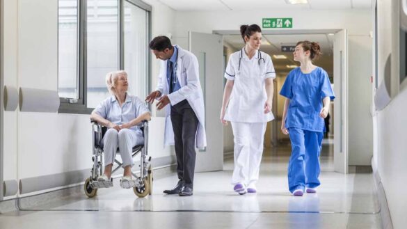 Level 7 apprenticeship funding. Photo shows NHS workers in a corridor