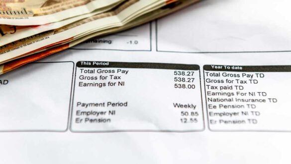 Median pay award March 2025. Photo shows a payslip and pound coins