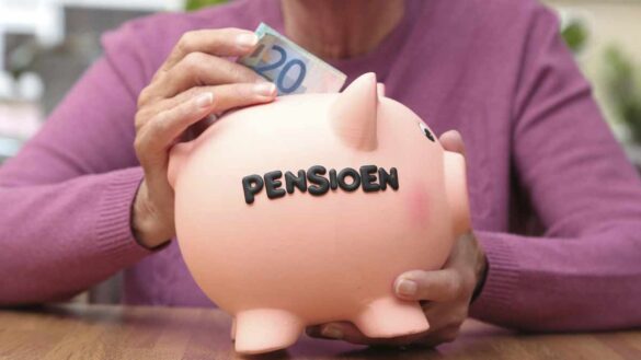 Multi-employer CDC schemes. Photo shows Dutch woman putting money into a piggy bank with the word "pensioen" written on the side.
