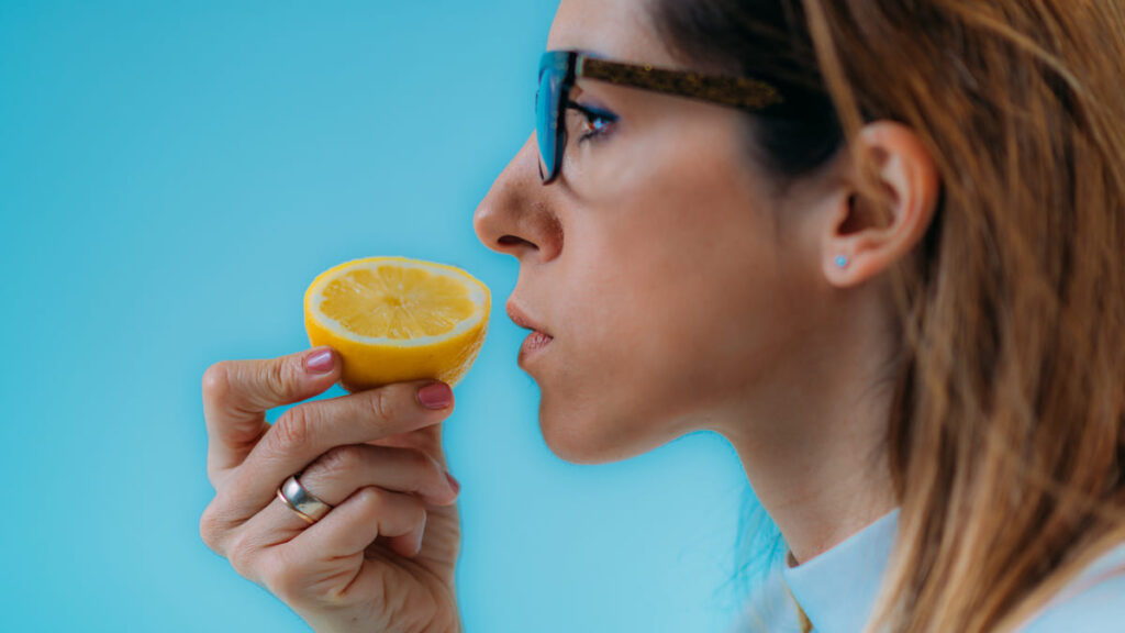 Woman sniffing a lemon