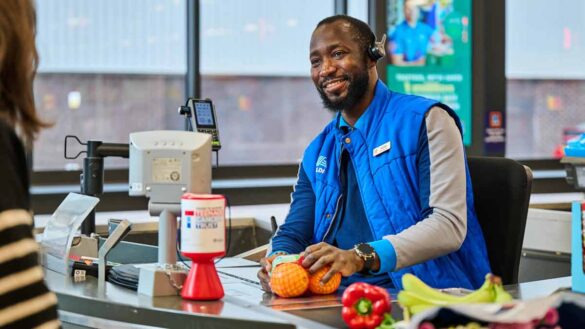 Aldi pay rise 2025 September. Photo shows a man on the tills at Aldi